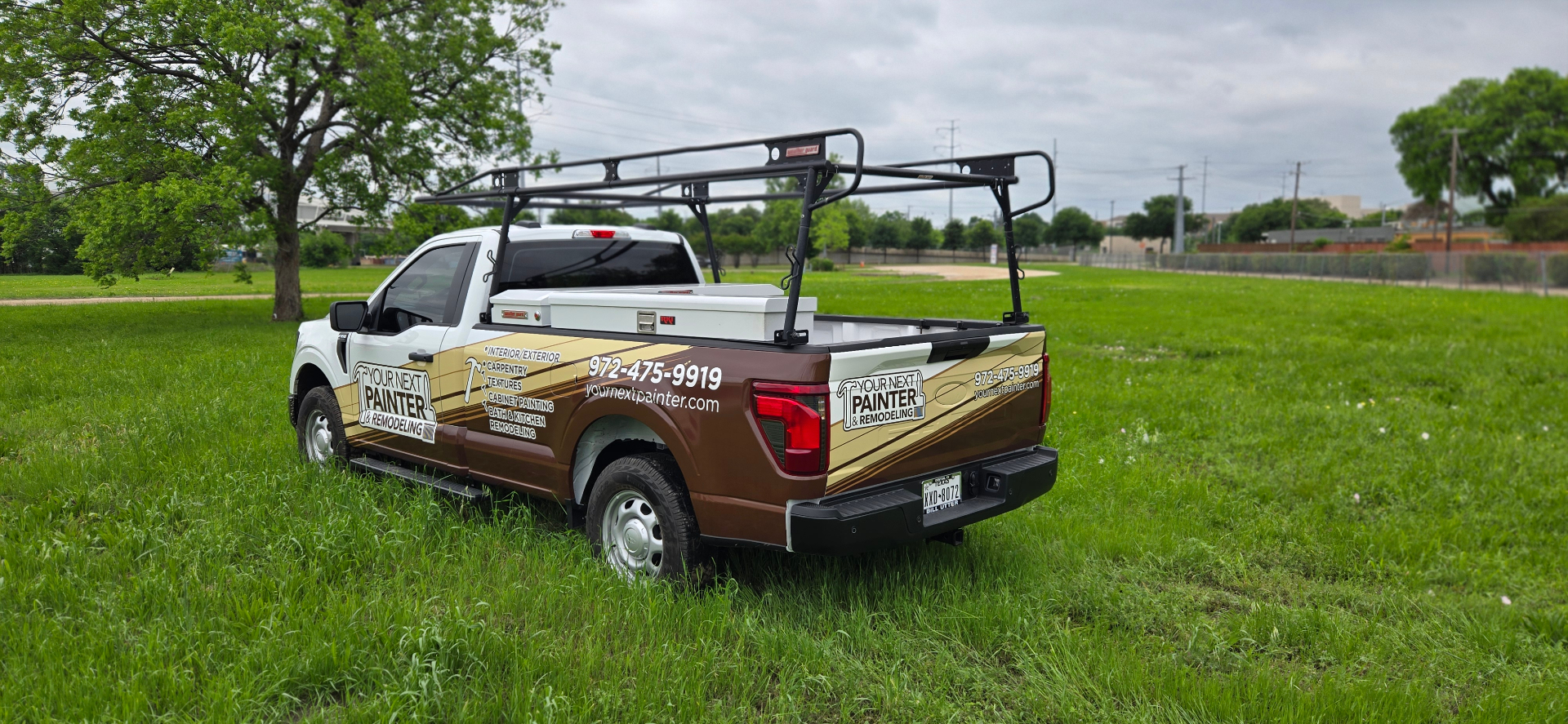 Your Next Painter & Remodeling work truck — rear view with branded tailgate and ladder rack